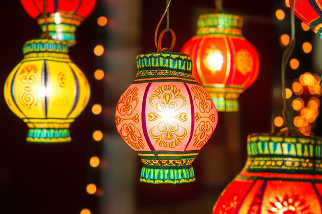 Close-up of vibrant, traditional Diwali lanterns, richly decorated and glowing warmly, illuminating a festive scene. Perfect for Diwali decoration inspiration.