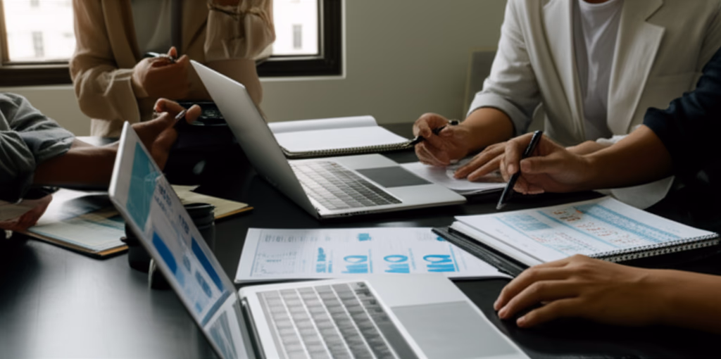 Diverse team collaborating on assessment evaluation, analyzing data, performance reports, and strategic insights for business improvement.