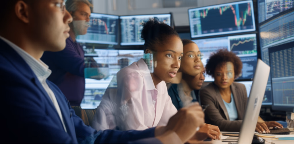 Realistic image depicting market sentiment with investors reacting to live stock market data, charts showing fluctuating trends, and a diverse group of people reflecting various emotions from optimism to caution.